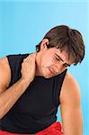 portrait of a young man having a headache over blue background