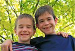 Two Boys Smiling with the Trees in Background