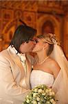 The groom and the bride kiss in church