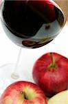 red wine in a glass with red apples