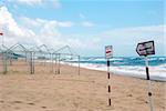 Structures and signs on a empty beach.  Miramar, Portugal.