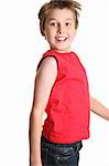 Happy smiling boy jumping into the air-  side view, white background