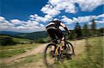 Male mtb biker during downhill event in motion blur
