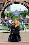 Tourist taking pictures of Eiffel tower in Paris, France.