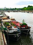 Row of houseboats docked on river Seine in Paris, France.