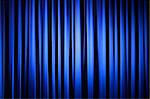 Spotlight on  A Blue Theater Curtain Before Show Begins