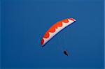 Paraglider on blue sky