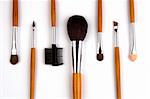 Cosmetic brushes lined up in white background.
