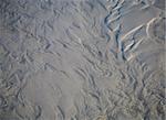 Shallow pristine sea water rippling over beach sand