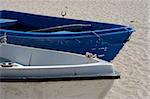 Two fishing boats standing on the sand of a beach