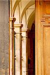 Arches seen through half open old wooden door