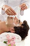 Facial Peel - A beautician performs a facial peel on a male client.