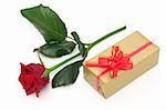 Red rose and a golden gift box
