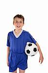 A boy wearing his soccer uniform and holding a soccer ball