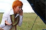 young red-haired woman with her broken car. The girl is angry