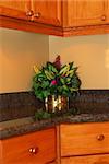 Detail of a modern kitchen interior with granite counter top oak cabinets