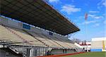 Emty tribunes on a soccer stadium under bright sky