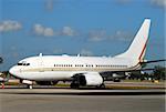 White jet airplane parked on the ground