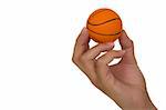 Feminine hand holding miniaturized rubber basketball over white background