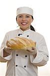 Smiling Chef holding baked bread loaf