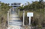 Private entrance to a beach front property on Sanibel beach, focus point is on the sign leaving the house slightly out of focus as aperture was fairly shallow, Sanibel Florida USA taken in March 2006