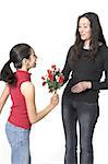 daughter offering flowers to her mother