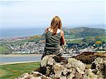 A tourist enjoying the view rom Conwy Mountain, Conwy, North Wales.