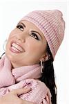 Attractive brunette smiling and looking fabulous in pink winter woollens