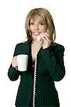 Woman standing up on a phone conversation holding a mug of coffee.