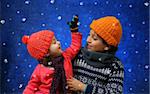 Brother and sister having fun with the snow in winter outfit. Look at my gallery for more winter images