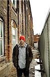 Man Standing in Muddy Alley