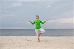active woman doing exercise on the beach