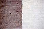 Brown and white brick exteriors of two old building come together and contrast each other.