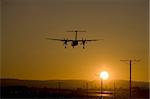 commuter airliner on final approach at sunset