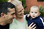 Bolnde woman and hispanic man with their cute baby boy