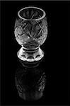 liqueur glass with reflection on deep black background