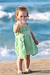 Beauty a little girl drinking bottle water at beach