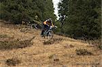Mountain biker downhill in forest