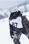 Snowboarder racer portrait in helmet and mask