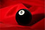 The billiard ball ¹8 laying on a red fabric