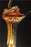 Honey with gold color isolated on black stock photo