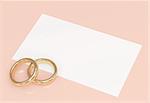 Background with wedding rings and a card
