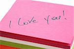Words about love written on a pink paper