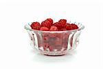 Raspberries in a crystal bowl isolated on the white background
