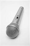 New and metal microphone on a grey background