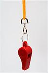 Beautiful red whistle on a yellow cord