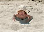 The baby girl plays with a sand