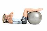 Blond woman in gym outfit exercising with a pilates ball