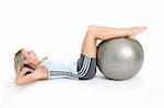 Blond woman in gym outfit excercising with a pilates ball