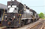 A Diesel Train Engine on railroad train tracks.